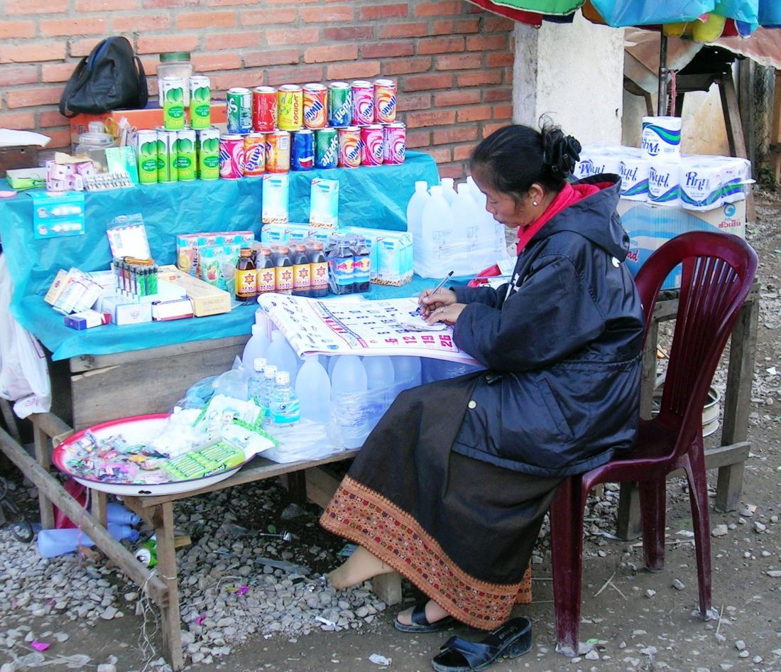 During the long wait for a customer, this woman devotes her time to cross checking the calender