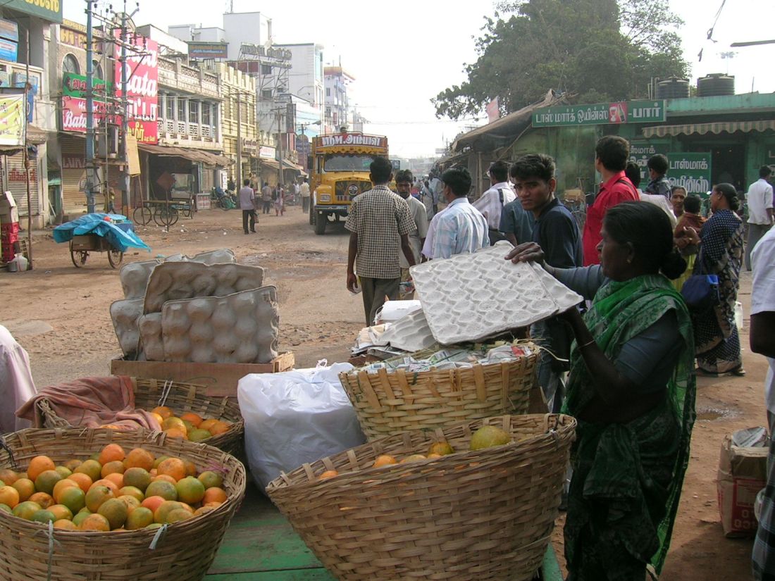 Oranges for sale....a low caste street vendor prepares for a long and hot day, India
